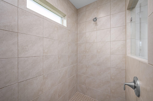 bathroom with a tile shower