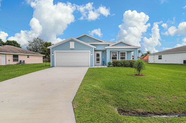 view of front of property featuring central air condition unit, a front yard, and a garage