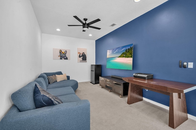 cinema with light colored carpet, visible vents, ceiling fan, and baseboards