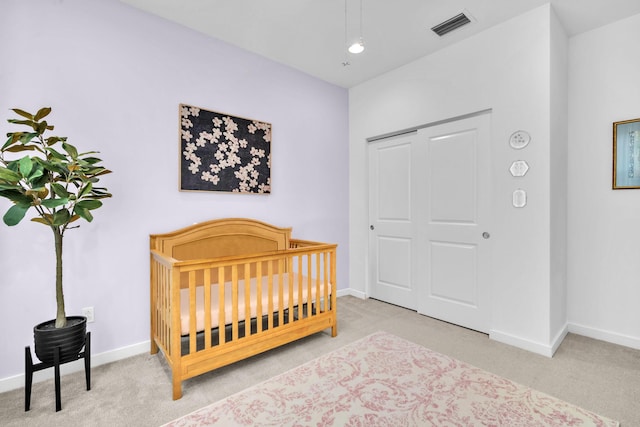 carpeted bedroom featuring a nursery area, visible vents, and baseboards