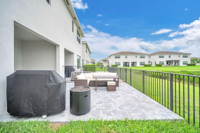 view of patio featuring a residential view, fence, an outdoor living space, and area for grilling