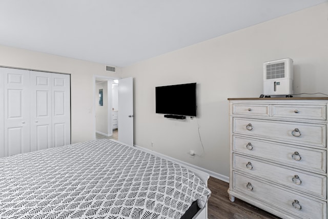 bedroom featuring a closet and dark hardwood / wood-style flooring