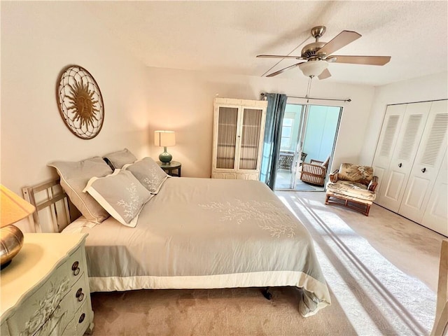 carpeted bedroom featuring a closet and ceiling fan