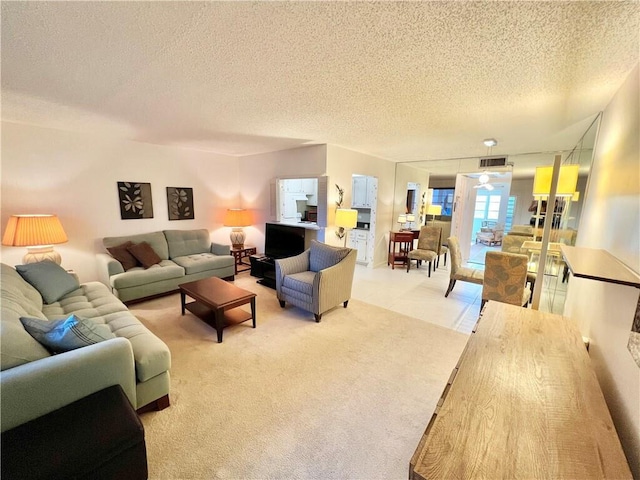 carpeted living room with a textured ceiling