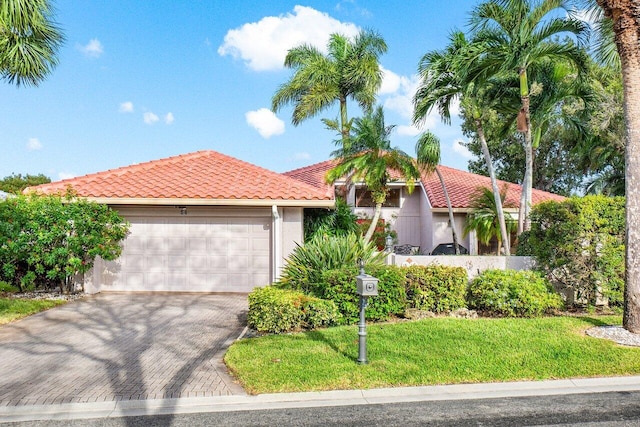 view of front of house featuring a garage and a front lawn