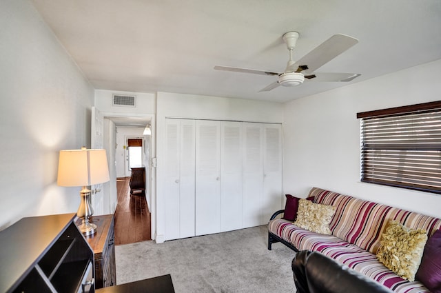 carpeted living room featuring ceiling fan