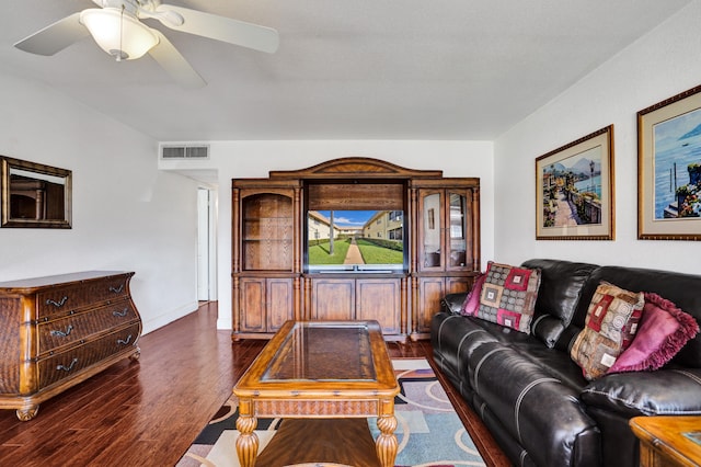 living room with ceiling fan and dark hardwood / wood-style flooring