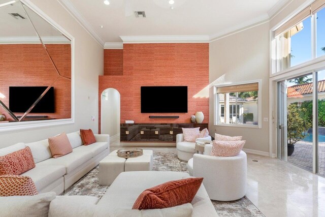 living room with crown molding and a wealth of natural light