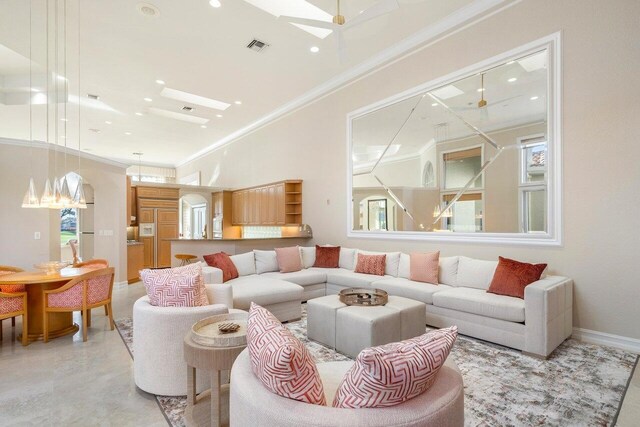 living room with ornamental molding and a skylight