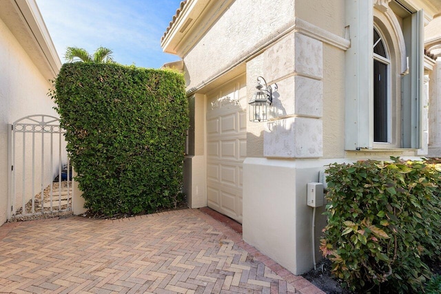 exterior space with stucco siding and fence