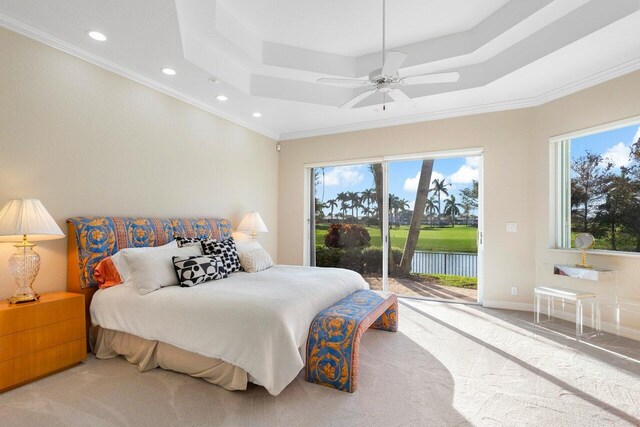 carpeted bedroom with ceiling fan, ornamental molding, access to exterior, and a raised ceiling