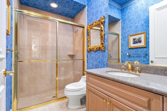 bathroom featuring vanity, toilet, a shower with shower door, and tile patterned flooring