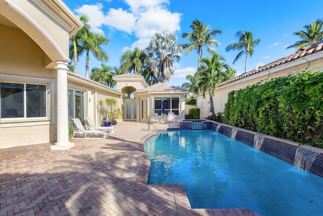 view of pool featuring a patio and a pool with connected hot tub