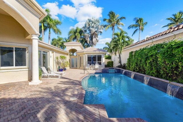 view of pool with pool water feature and a patio