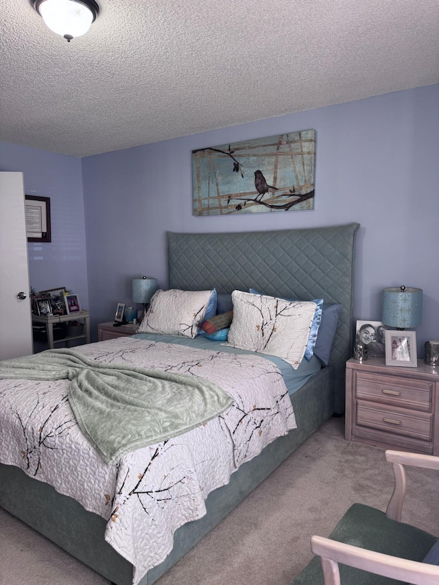 carpeted bedroom featuring a textured ceiling