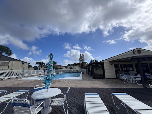 view of swimming pool with a wooden deck