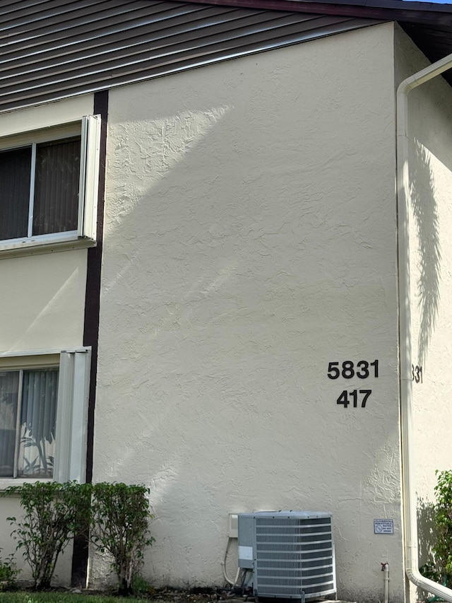 view of side of home featuring central AC unit