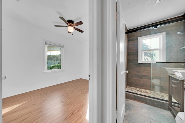 bathroom featuring walk in shower, vanity, toilet, and plenty of natural light