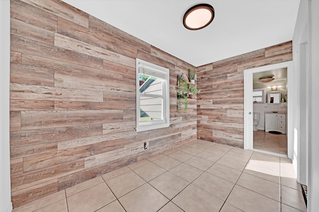 spare room with wooden walls and light tile patterned floors