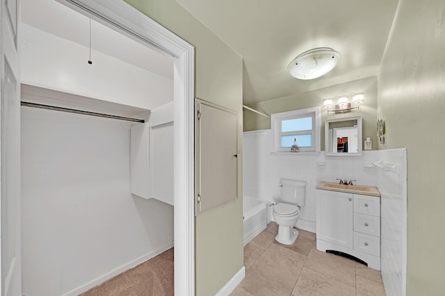 full bathroom with tile walls, toilet, vanity, tile patterned floors, and shower / bath combination