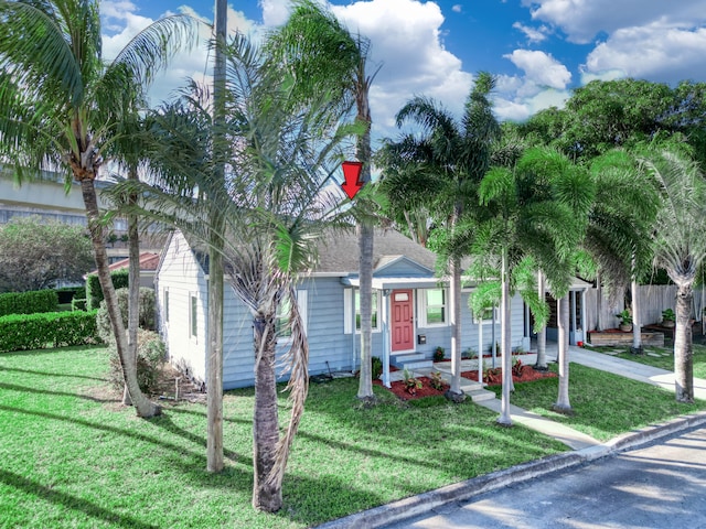 obstructed view of property featuring a front lawn