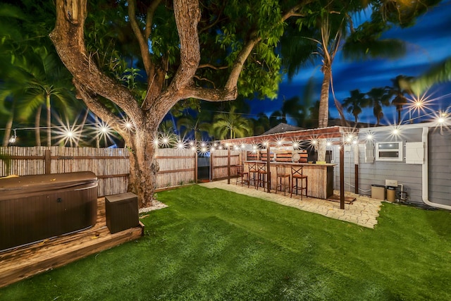 view of yard featuring a hot tub and exterior bar