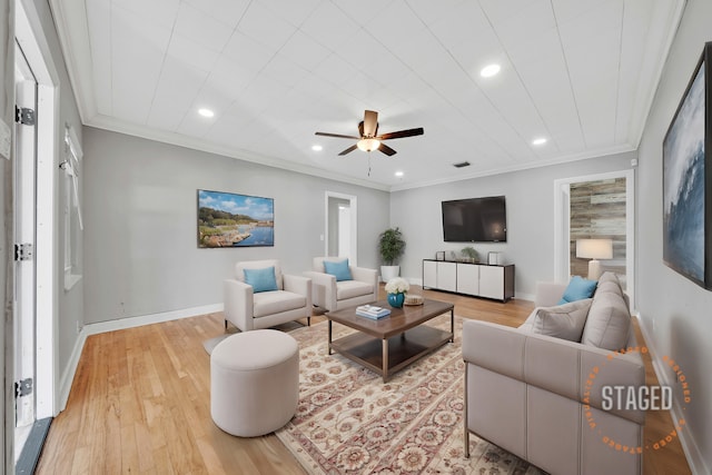 living room featuring light hardwood / wood-style floors, crown molding, and ceiling fan