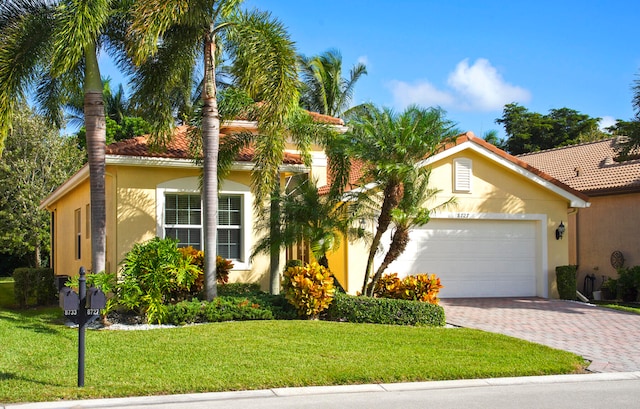 view of front of home with a garage and a front yard