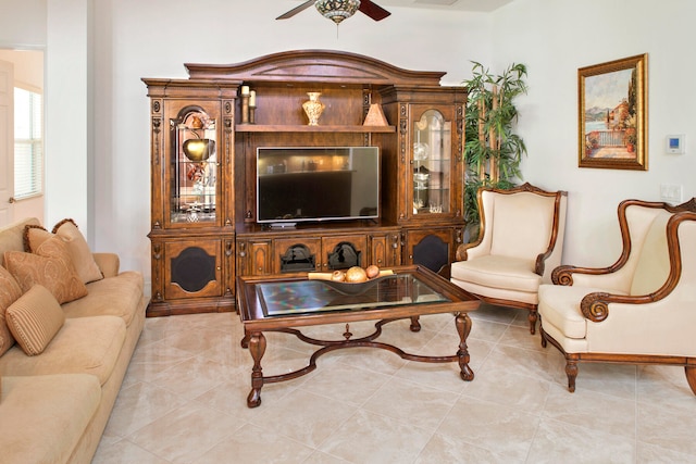 sitting room with ceiling fan and light tile patterned floors