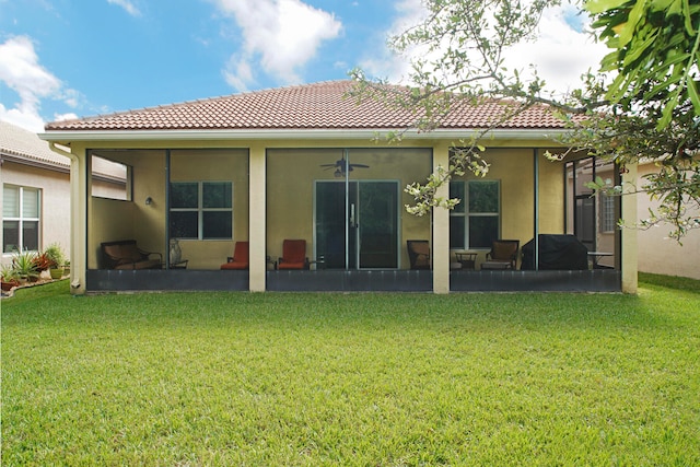 rear view of property featuring a lawn and a patio