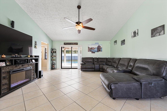 living room with ceiling fan, a textured ceiling, high vaulted ceiling, and light tile patterned floors