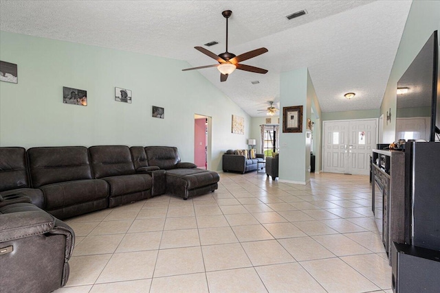 tiled living room with a textured ceiling, high vaulted ceiling, and ceiling fan