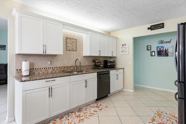 kitchen with decorative backsplash, dark stone countertops, sink, black appliances, and white cabinetry