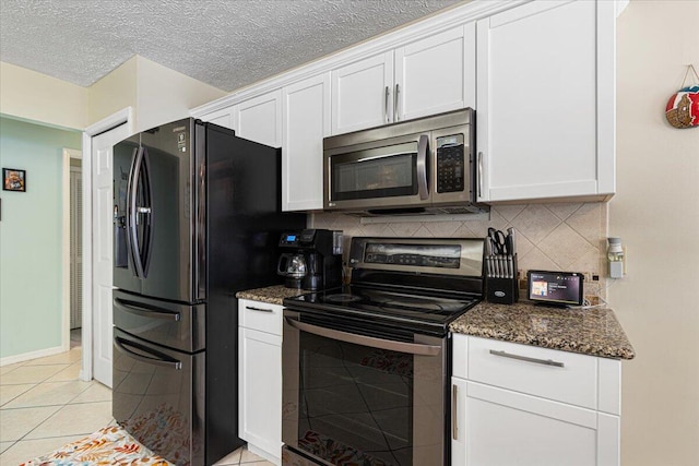 kitchen with decorative backsplash, white cabinetry, dark stone countertops, and black appliances