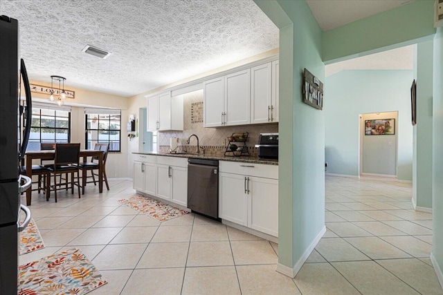 kitchen featuring white cabinetry, black appliances, and a textured ceiling