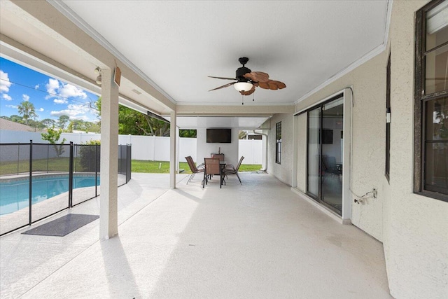 view of patio / terrace with a fenced in pool and ceiling fan