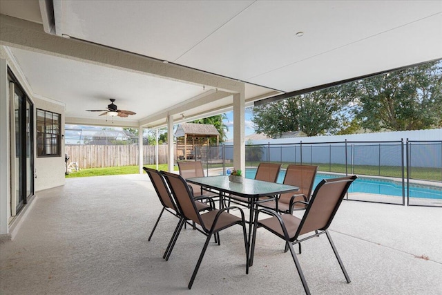 view of patio / terrace with a fenced in pool and ceiling fan