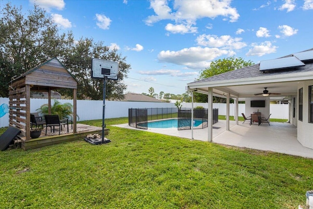 view of yard featuring a patio, ceiling fan, and a fenced in pool