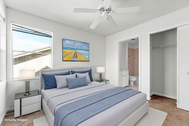 bedroom featuring connected bathroom, carpet floors, a closet, and ceiling fan