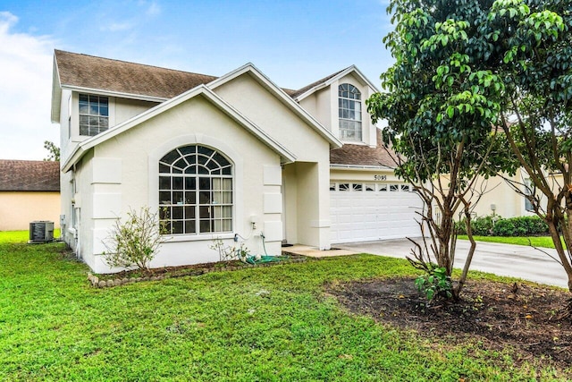 front facade featuring cooling unit, a front yard, and a garage