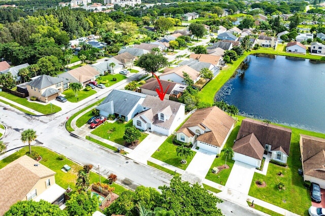 birds eye view of property with a water view