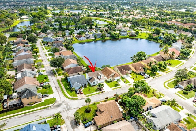 birds eye view of property with a water view