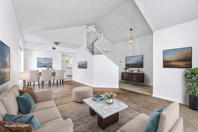 living room with hardwood / wood-style flooring and high vaulted ceiling