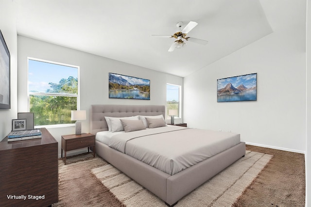 bedroom featuring carpet, ceiling fan, lofted ceiling, and multiple windows