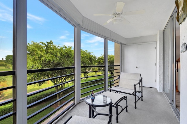 sunroom featuring ceiling fan