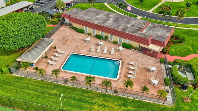 view of swimming pool with a yard, central air condition unit, and a patio