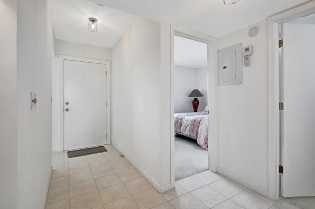 hallway with electric panel and light tile patterned floors