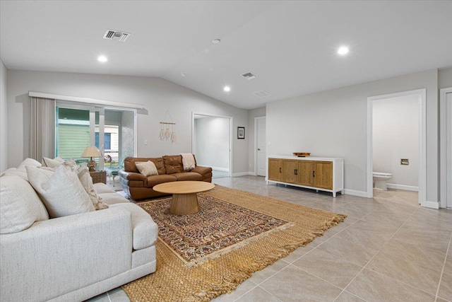 tiled living room featuring lofted ceiling