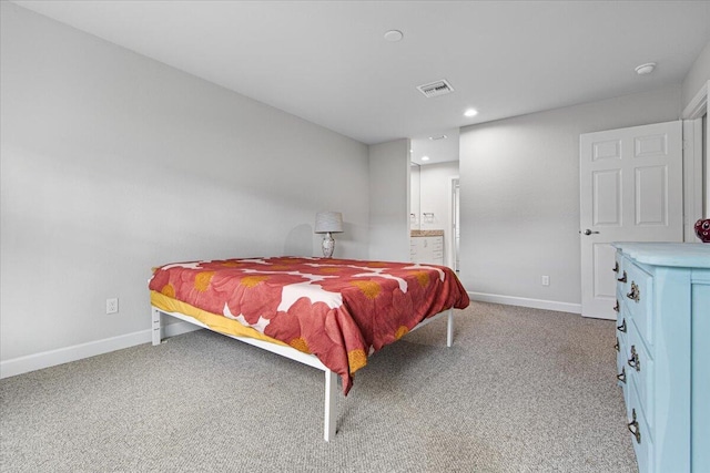 carpeted bedroom with connected bathroom