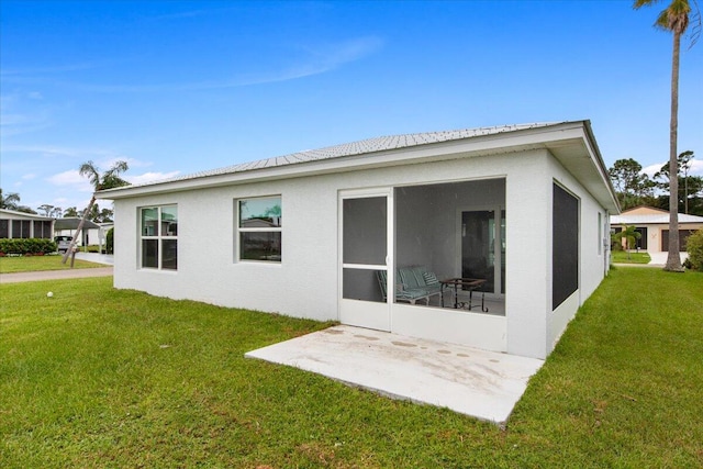 back of property featuring a yard and a patio